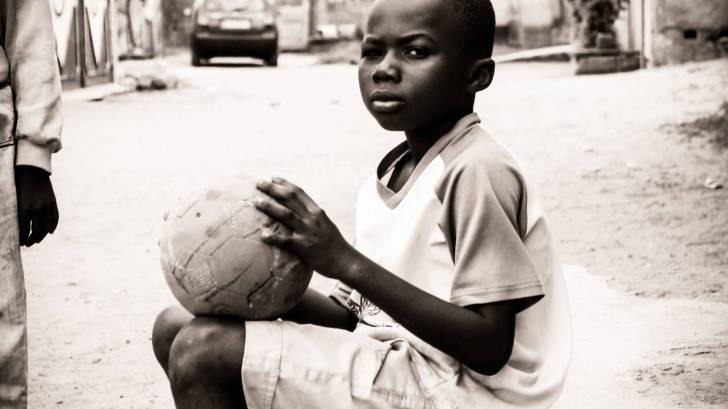 young african child with a basket ball