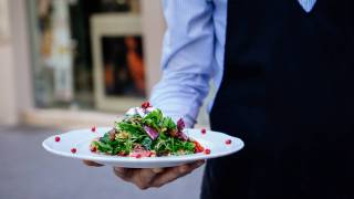 waiter serving a salad